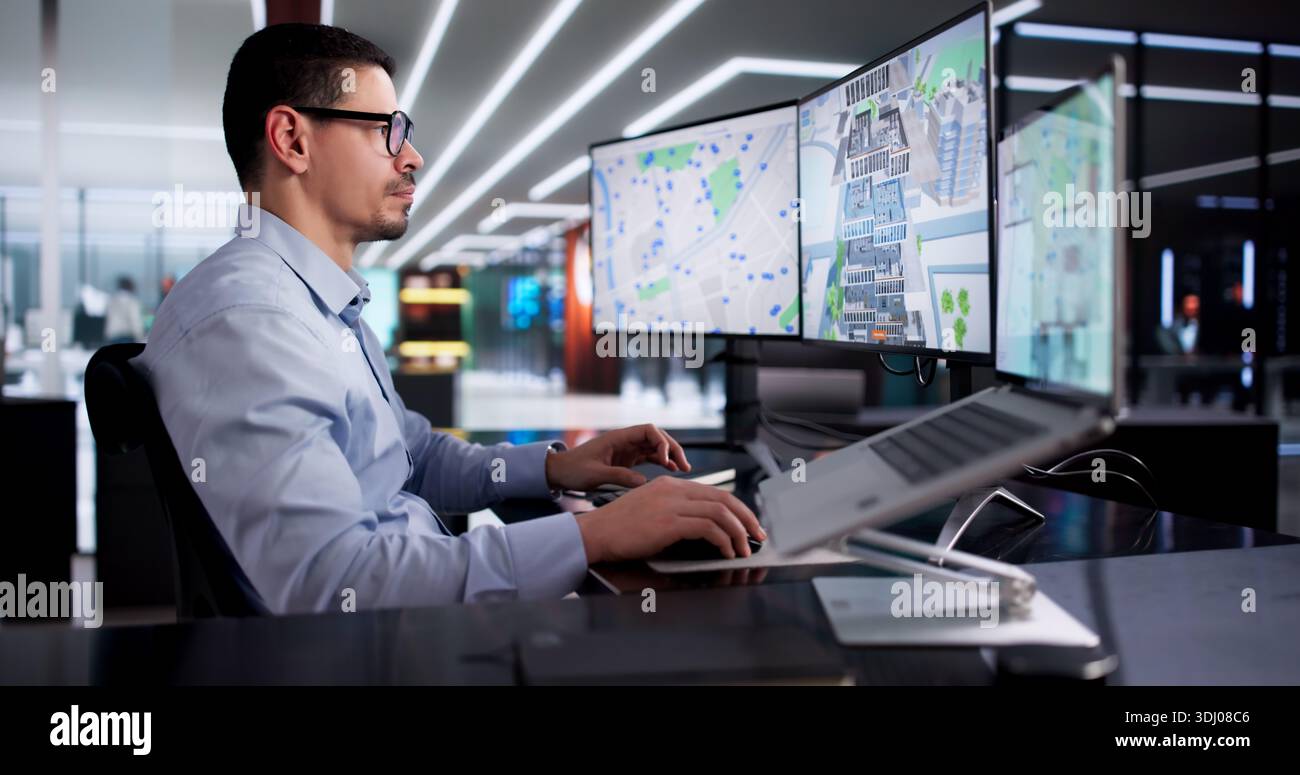 Young Hispanic Man Using CAD Software To Design Commercial Building. Stock Photo