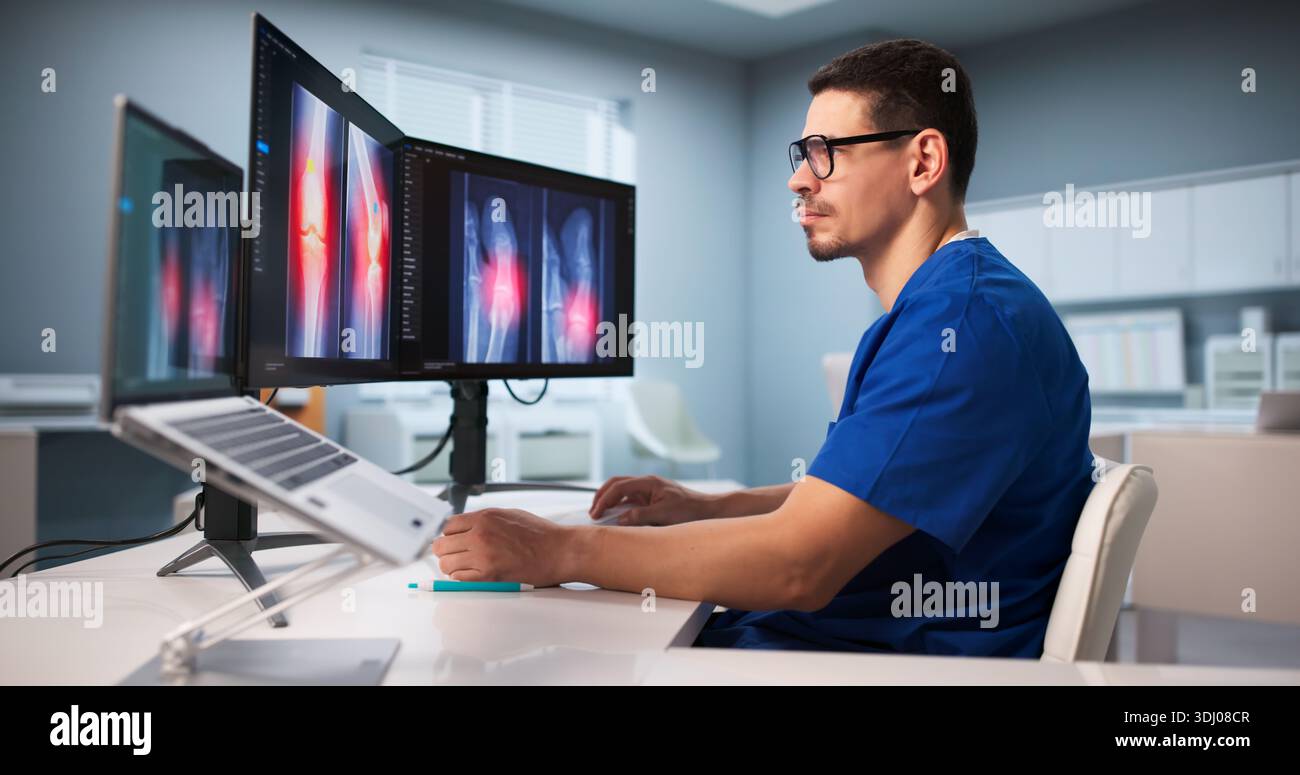 Surgeon Examining Knee X-ray Scan Using Software Technology At Hospital. Stock Photo