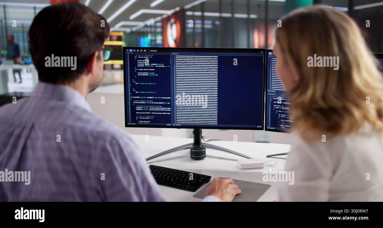 Two Mature Individuals Developing Web Software With Instructor Guidance Stock Photo