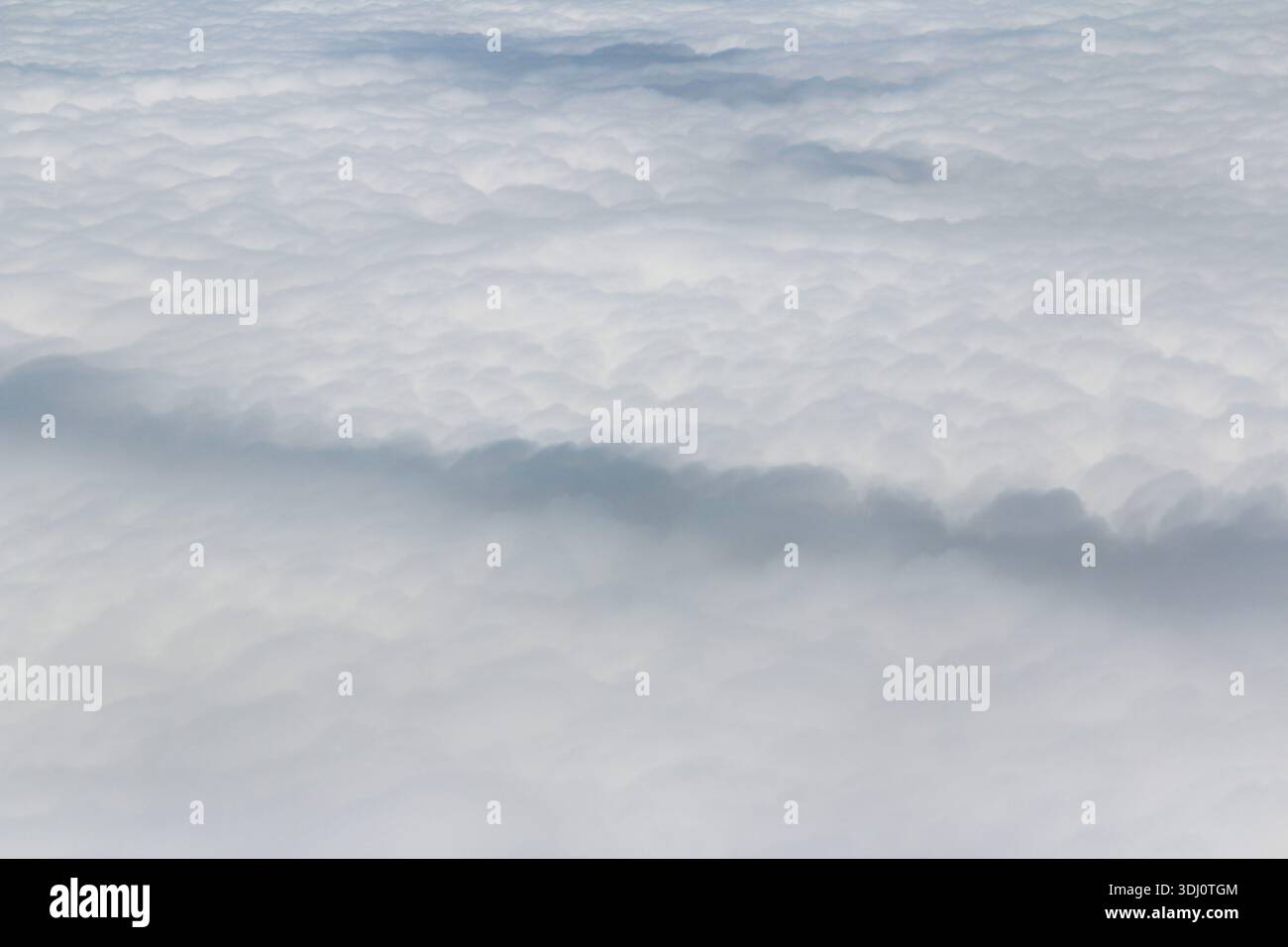 Dramatic and fluffy cloudscape from the airplane's window Stock Photo