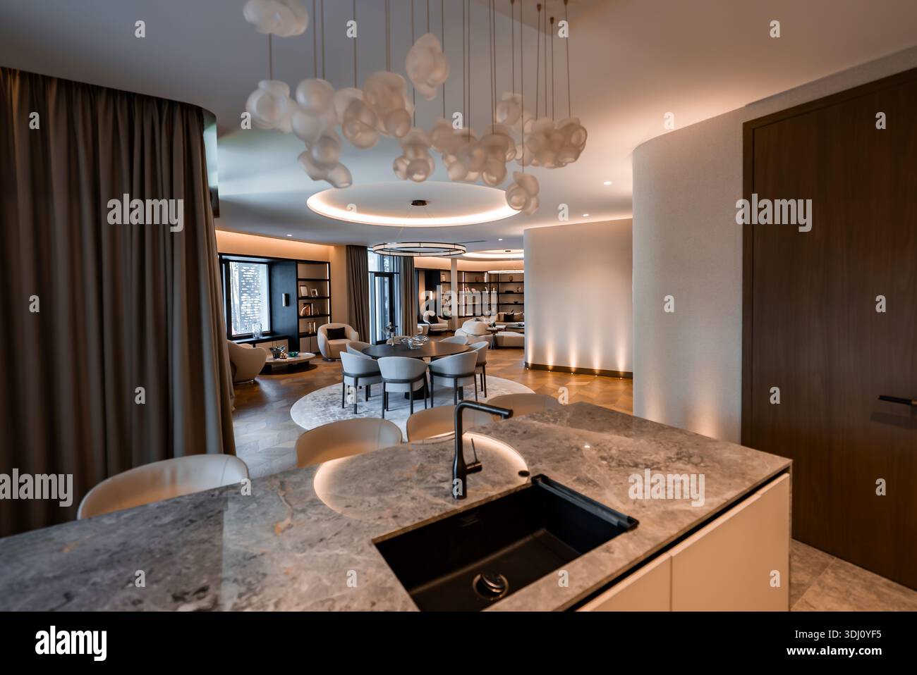 Contemporary luxury apartment interior with marble island and lounge Stock Photo