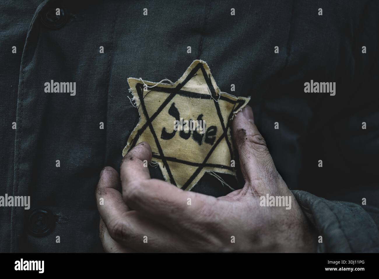hand holding a Star of David badge, a symbol of Jewish identity ...