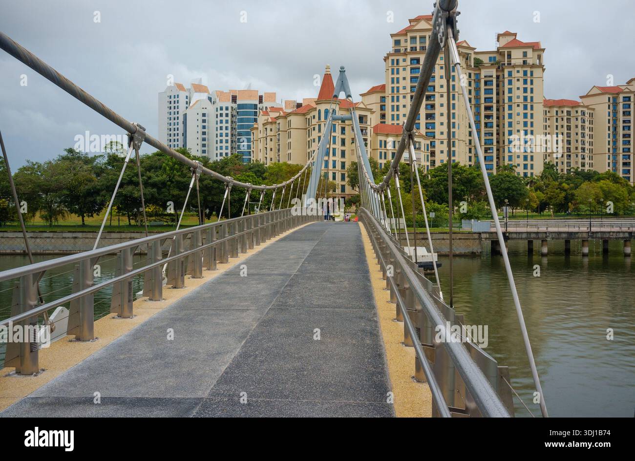Tanjong Rhu pedestrian Suspension bridge for crossing the Geylang River Singapore. A footbridge connecting MRT,  residential and sporting complex. Stock Photo