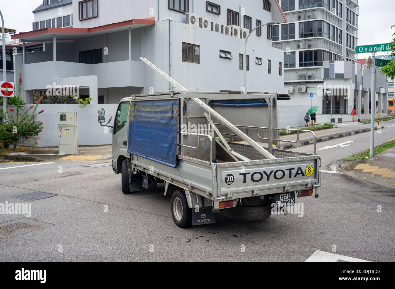 A Toyota dropside van entering a cross road at Onan Road Singapore. A workhorse and common van seen on the roads of Singapore. Stock Photo