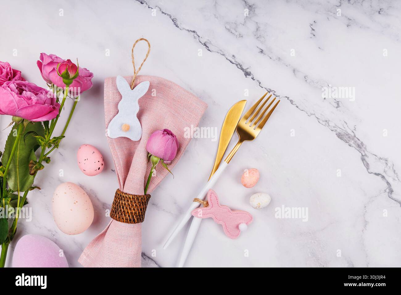 Elegant Easter Table Composition with Roses and Cutlery Stock Photo