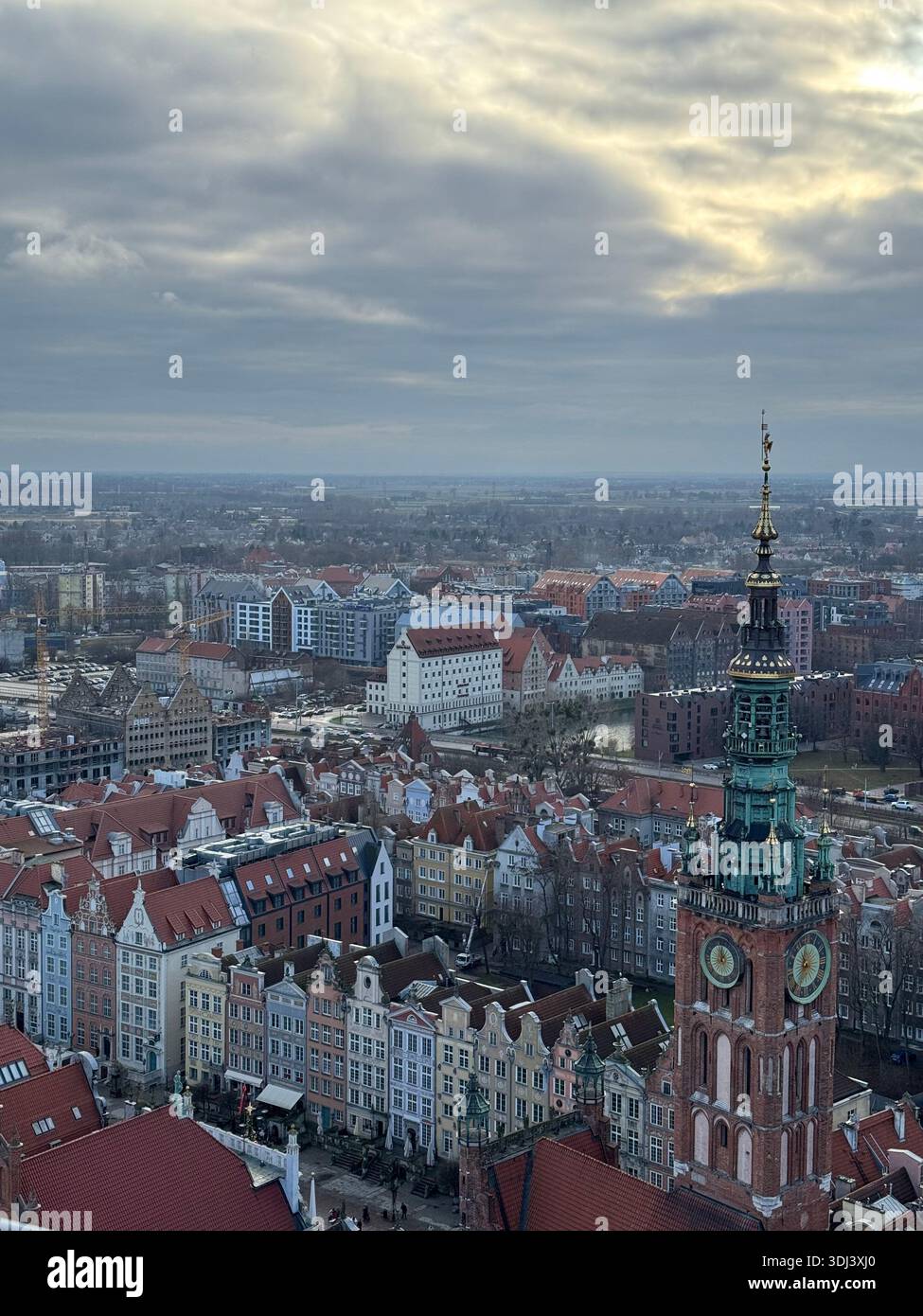Aerial view of the Old Town of Gdańsk, Poland, with historic rooftops and the tower of St. Mary’s Church dominating the city skyline - Smartphone Captured Stock Image