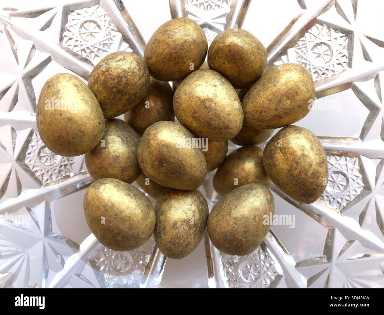 Gold coloured chocolate Easter eggs isolated on background Stock Photo