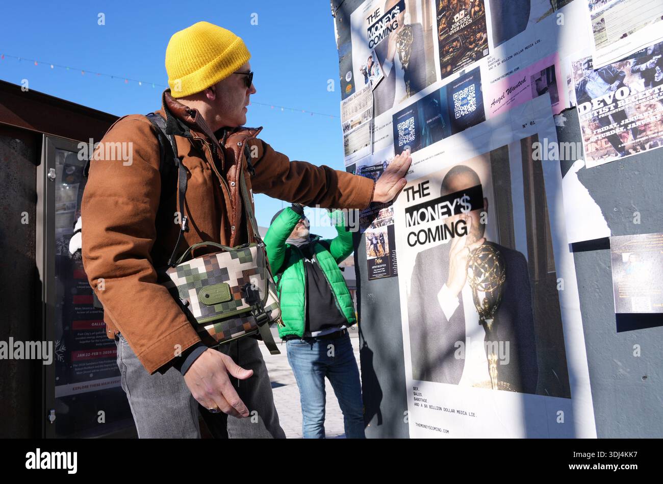 Jason Bitensky puts up a flyer for his first novel, 