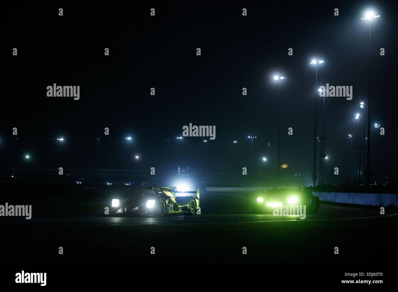 DAYTONA BEACH, FL - JANUARY 24: Cars race during the night during the ...