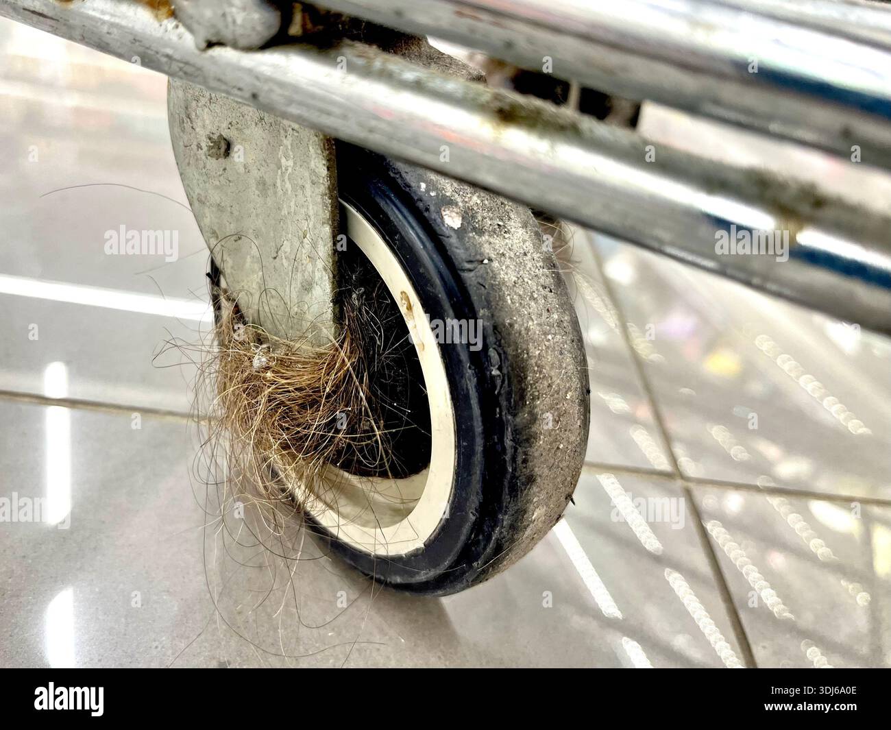 Dirty shopping cart trolley wheel collected hairs, dirt, shopping, consumerism, hygiene - Smartphone Captured Stock Image