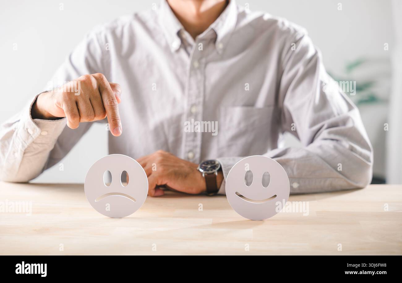 Person points to sad face, showing emotional contrast for customer ...