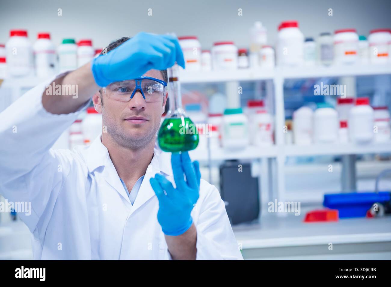 Male scientist adding solution hi-res stock photography and images - Alamy