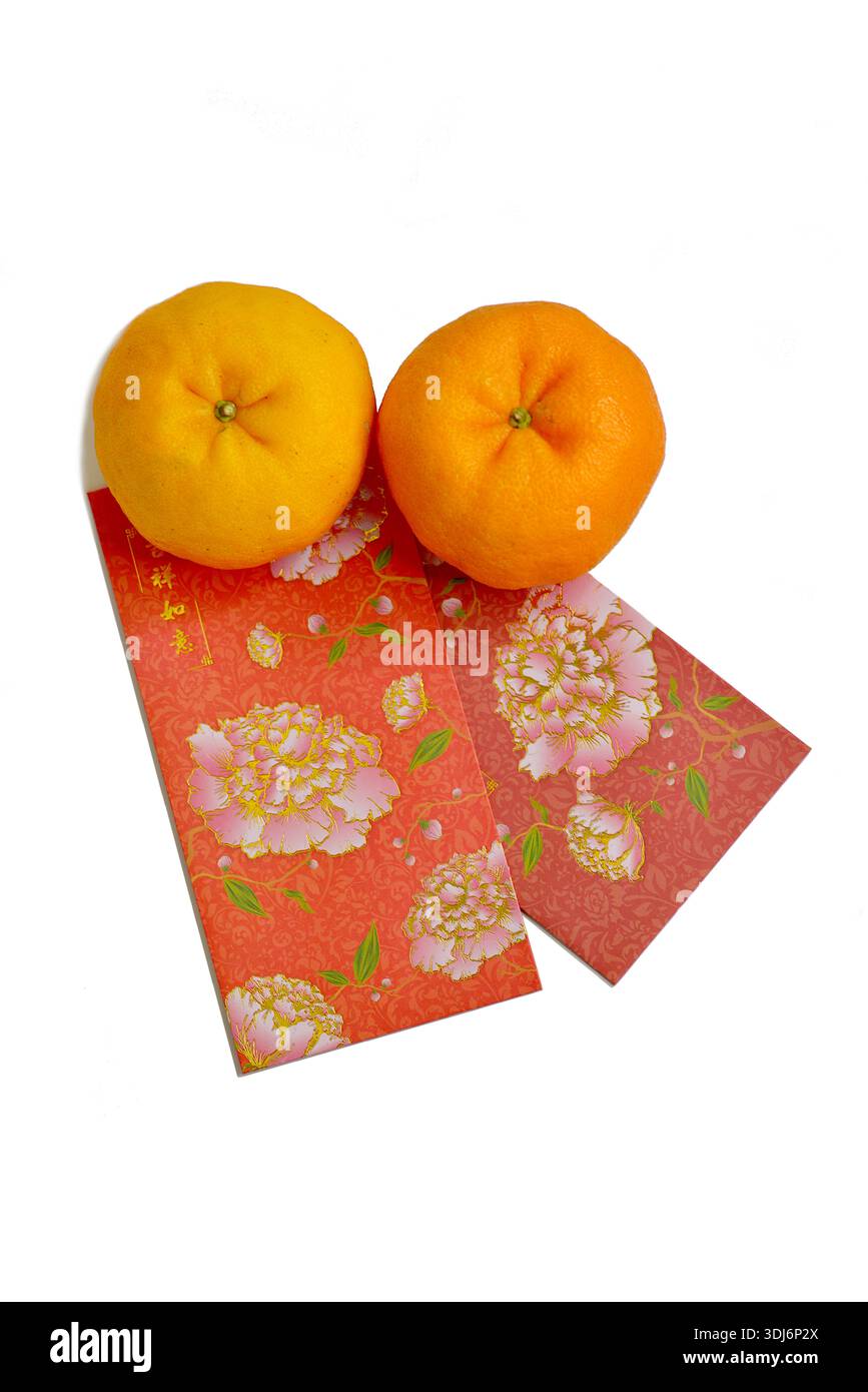 Two Lukan mandarin oranges variety, Chinese New Year red packets decorated with peony flowers and blessings for good luck, isolated on white Stock Photo