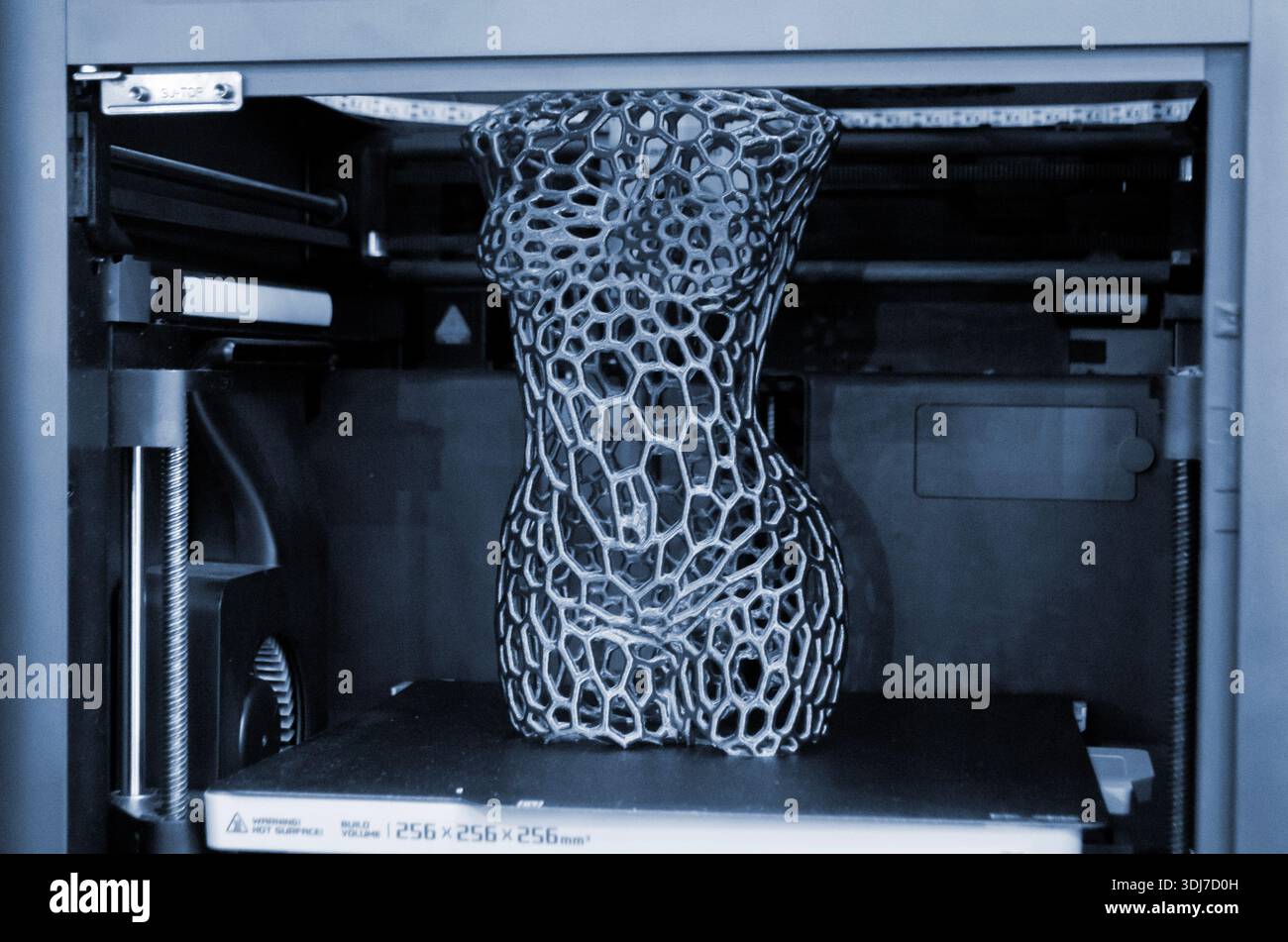 Art model printed on 3D printer from molten plastic. Object created on 3D printer inside printer. Form printed on 3D printer from blue plastic on the working surface. Concept 3D printing technology Stock Photo