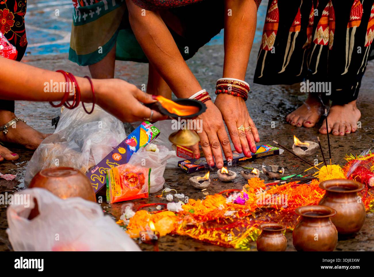 Hindu religious ritual with offerings, oil lamps and incense during ...