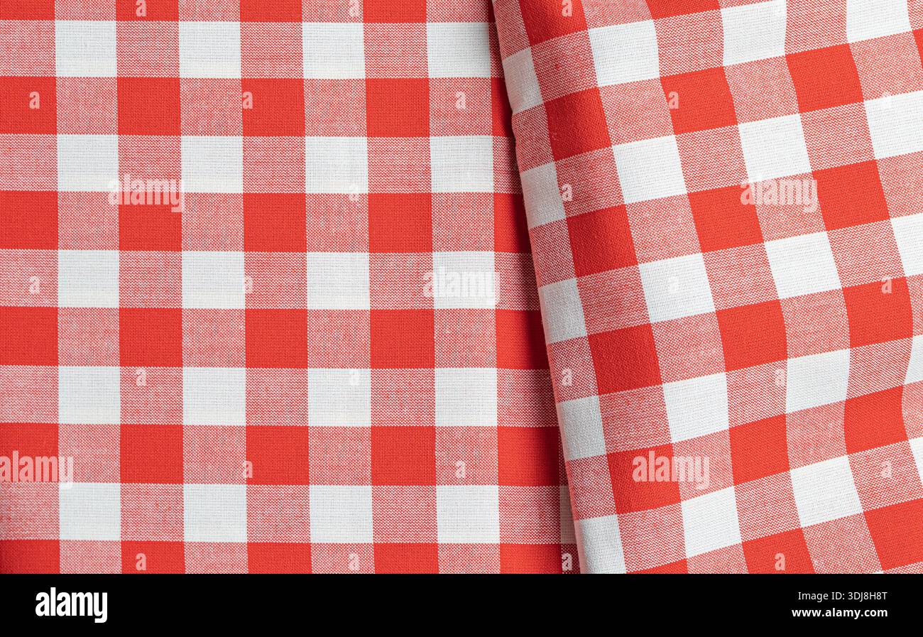 Red and white checkered fabric creating a classic gingham tablecloth texture Stock Photo