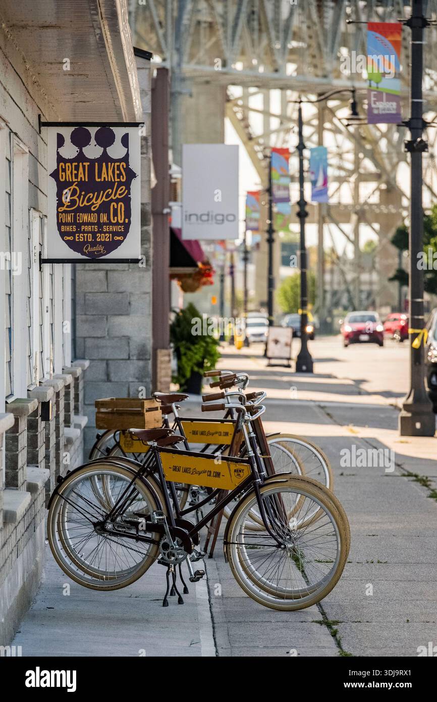 Bike shop in Point Edward, Ontario near Sarnia with Blue Water Bridge to Port Huron, Michigan visible in background. Stock Photo