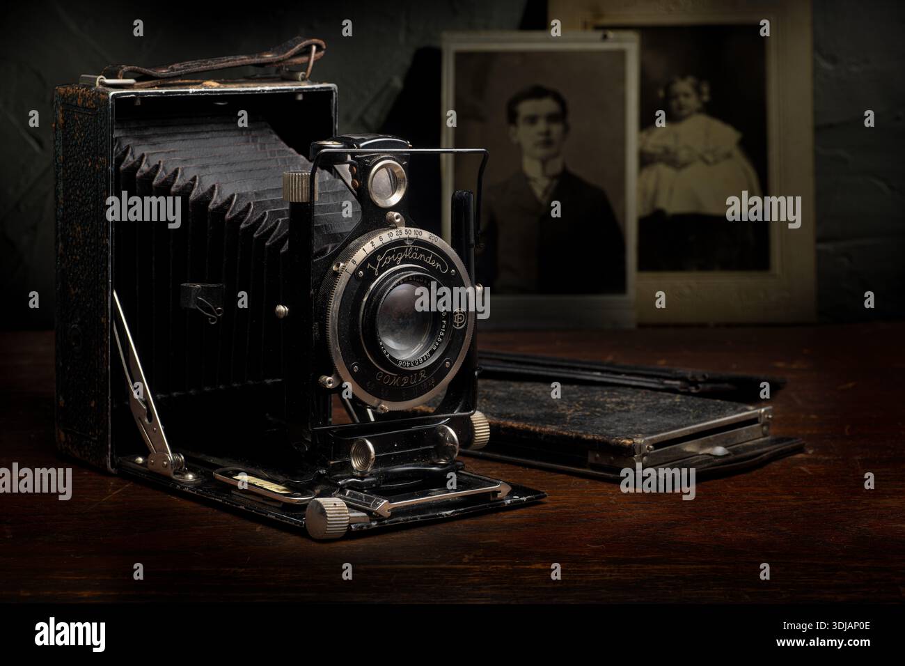 Old camera, film backs, and vintage photos as a still life. Stock Photo