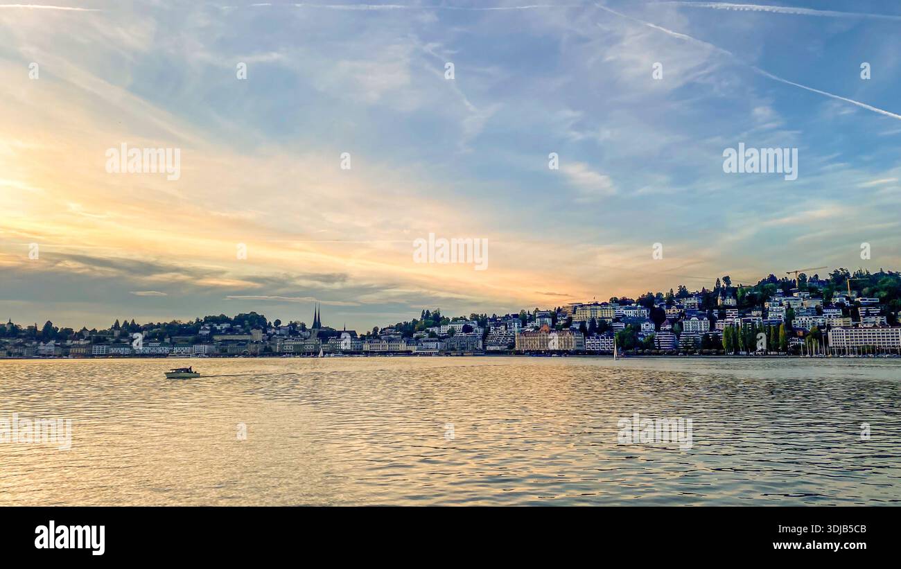 wide-angle landscape of the Lucerne skyline featuring the Hofkirche St. Leodegar towers and Swiss architecture under a soft sunset sky with reflection - Smartphone Captured Stock Image