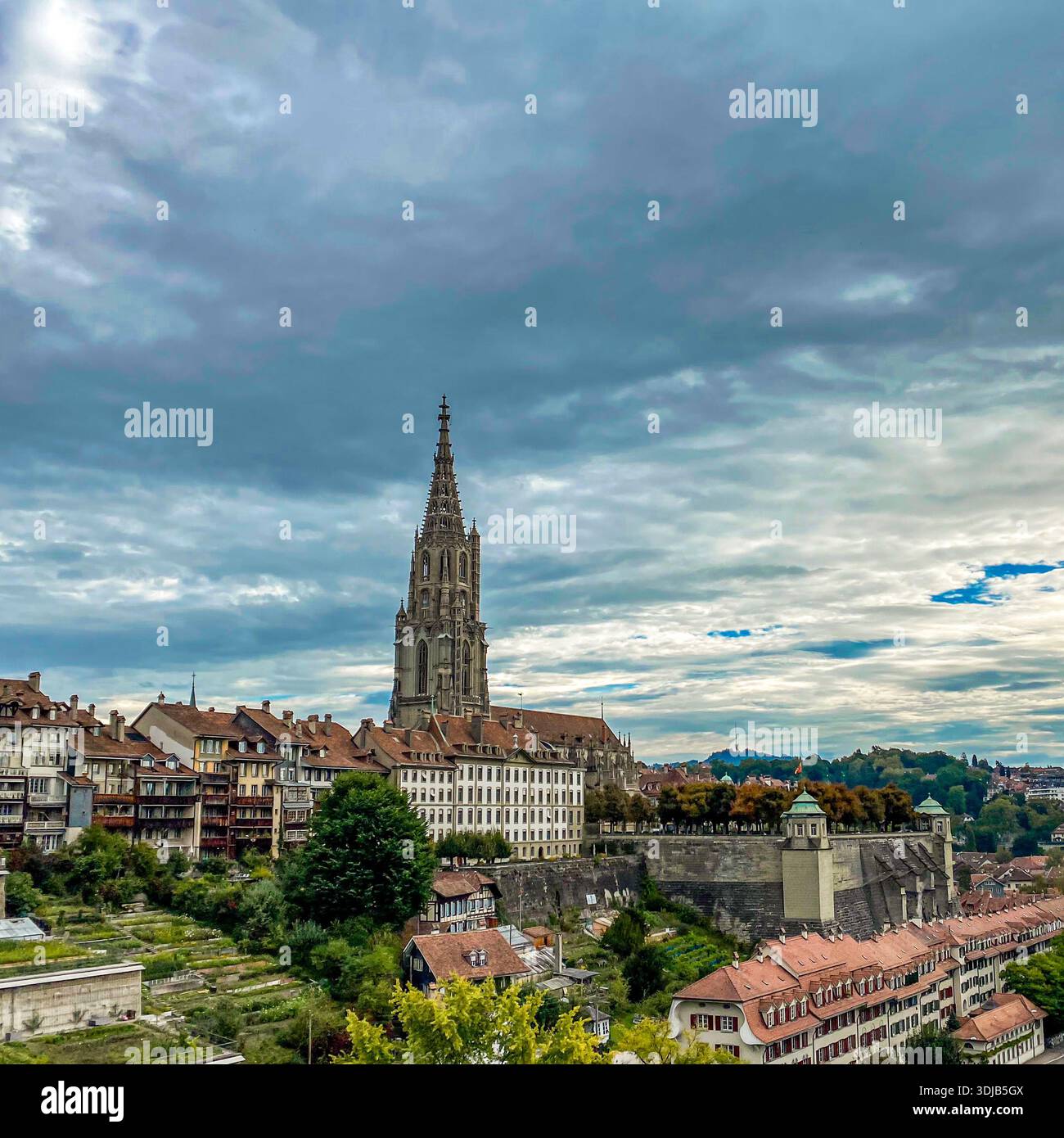 A scenic view of the Bern Minster (Berner Münster) towering over the historic Old Town of Bern, Switzerland. The image captures the intricate Gothic a - Smartphone Captured Stock Image