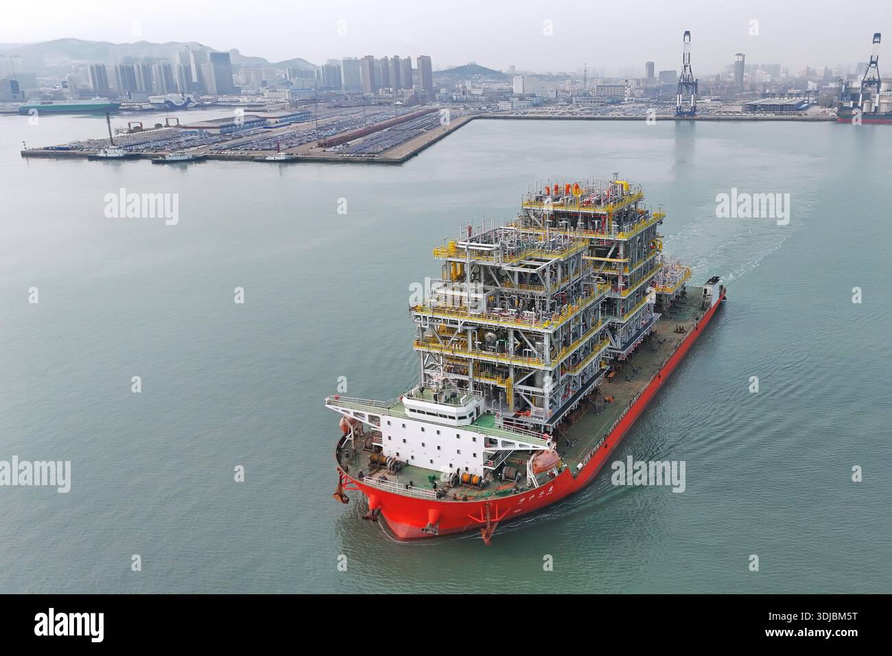 A deck barge carrying modules for a domestically built floating ...
