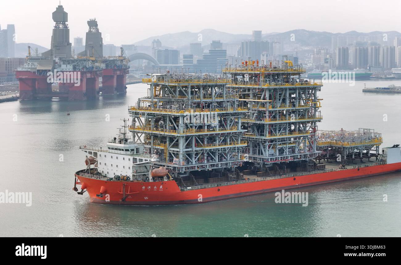 A deck barge carrying modules for a domestically built floating ...