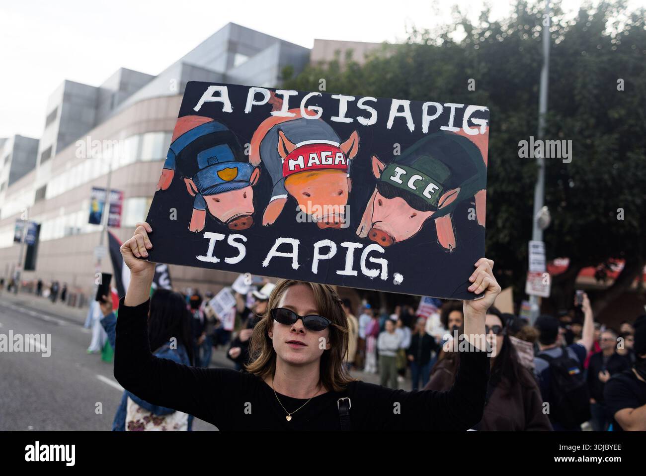 Pigs Protesting Los Angeles, United States. 25th Jan, 2026. A protester holds a hand ...