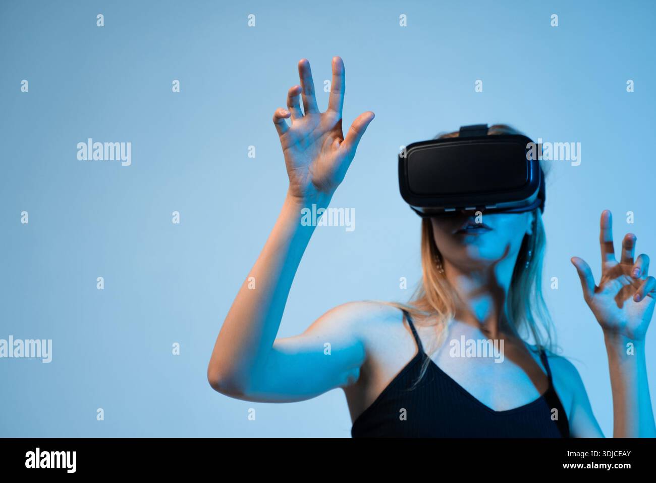 Woman interacting in virtual space using VR headset, immersive digital technology and future innovation Stock Photo