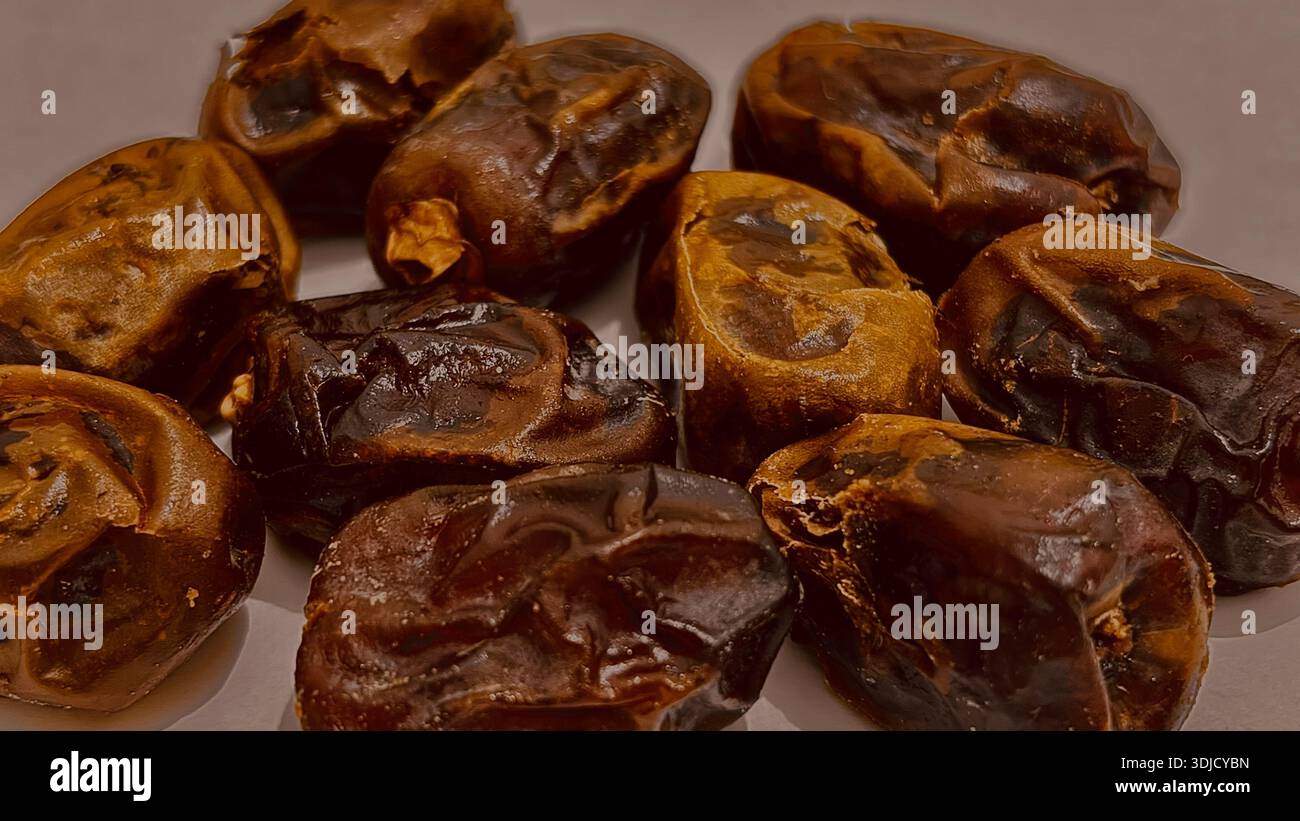 Close-up of dried dates fruit arranged on a plate, showing rich brown color and natural texture, commonly associated with healthy food, and Ramadan. - Smartphone Captured Stock Image