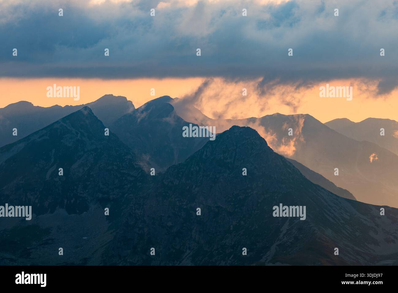 Hrubya Aerial view of the rugged, dark peaks of Hruby vrch pierce through a ...