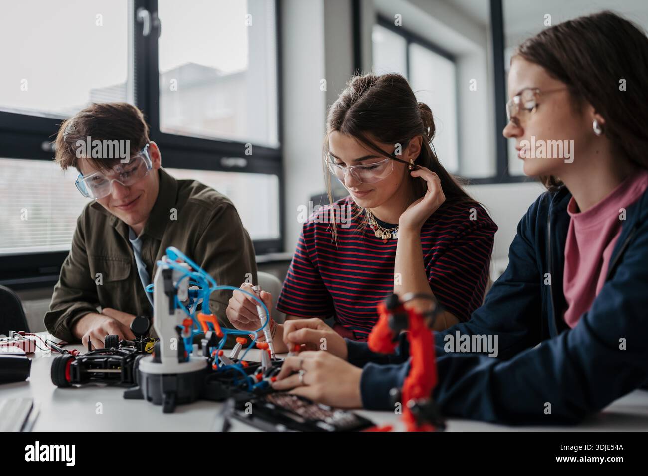 Students Using Robotics High school students working on robotics project as team Stock Photo ...