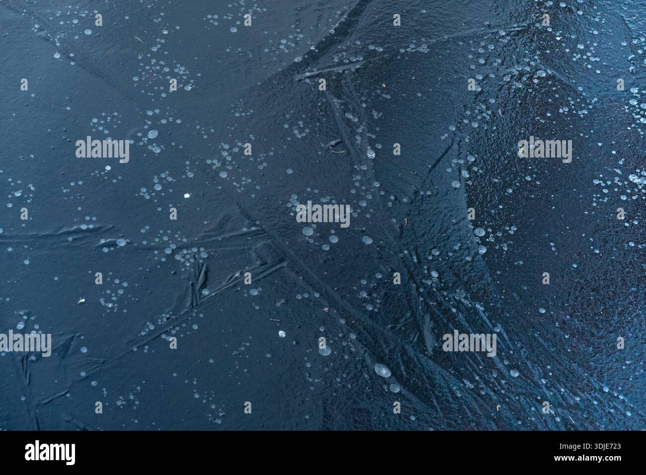 Air bubbles caotured in blue ice Stock Photo