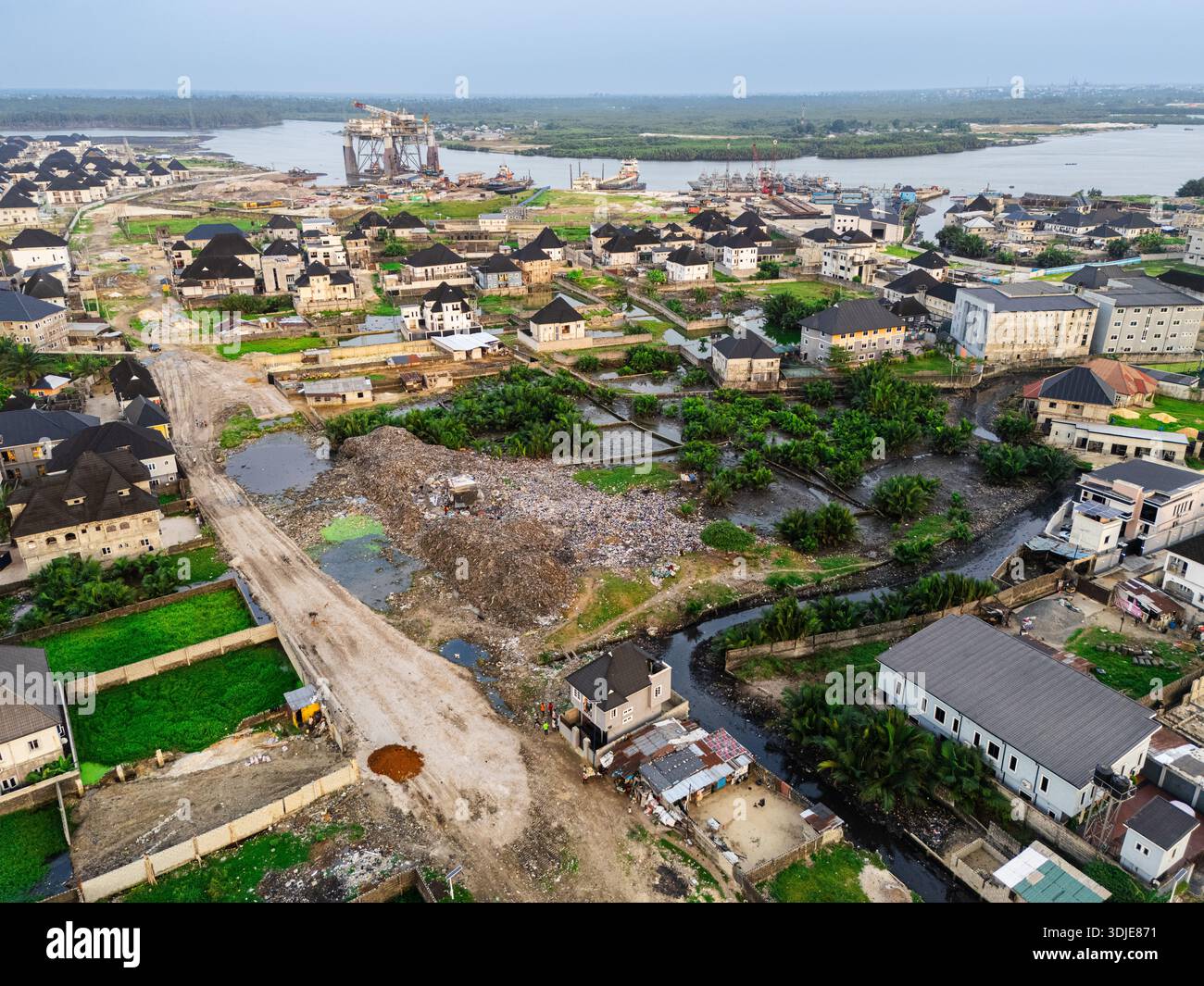 Aerial View Of Houses And Buildings Scattered Across The Landscape With aerial-view-of-houses-and-buildings-scattered-across-the-landscape-with
