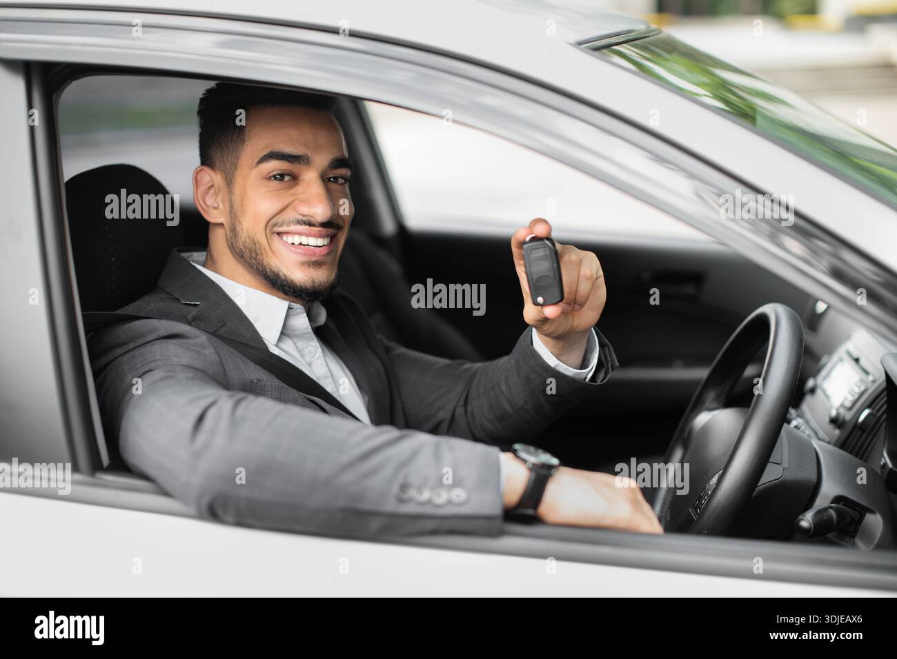 Handsome arabic businessman holding automatic car key Stock Photo
