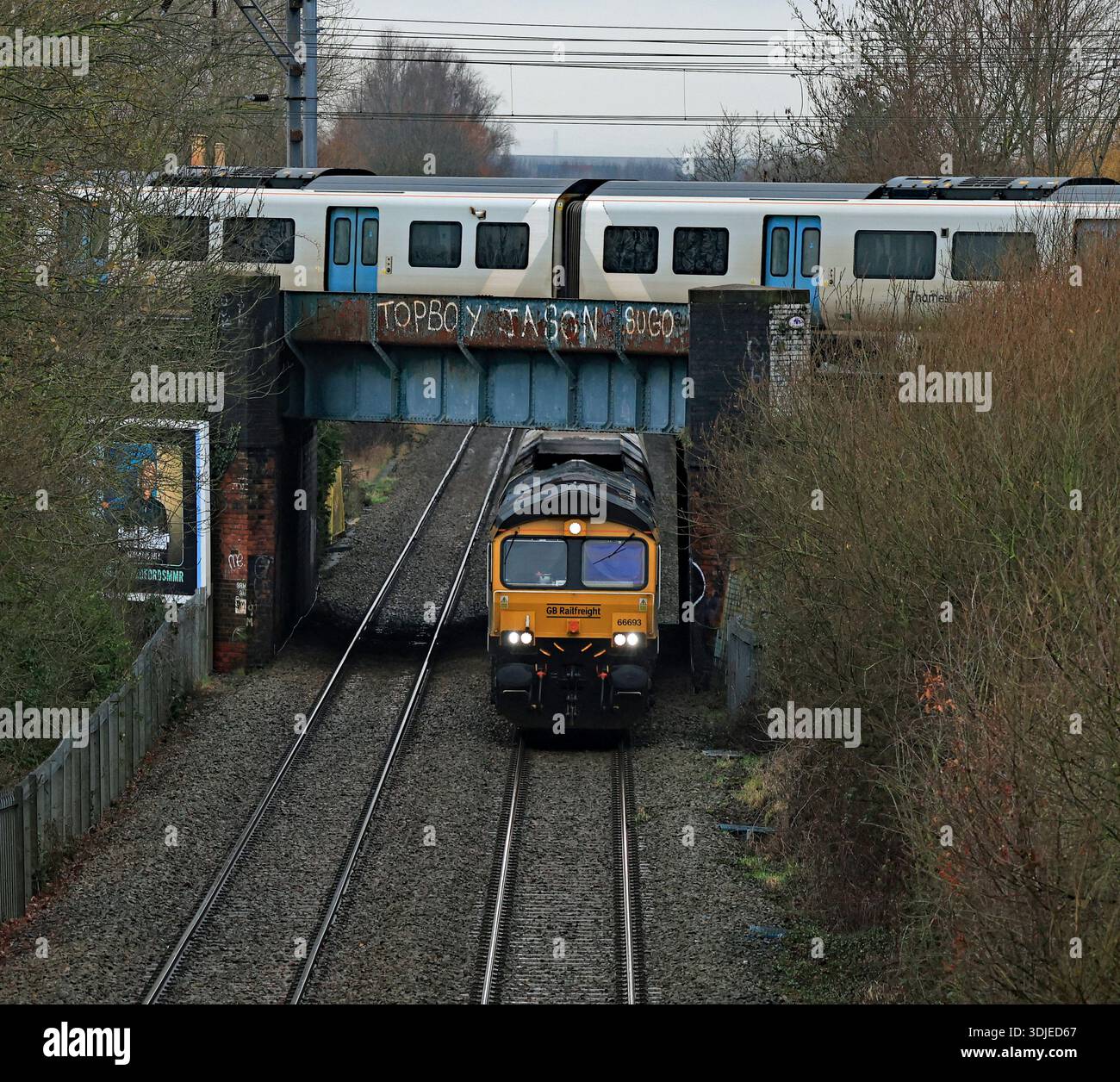 Passenger train crosses over a freight train hi-res stock photography ...