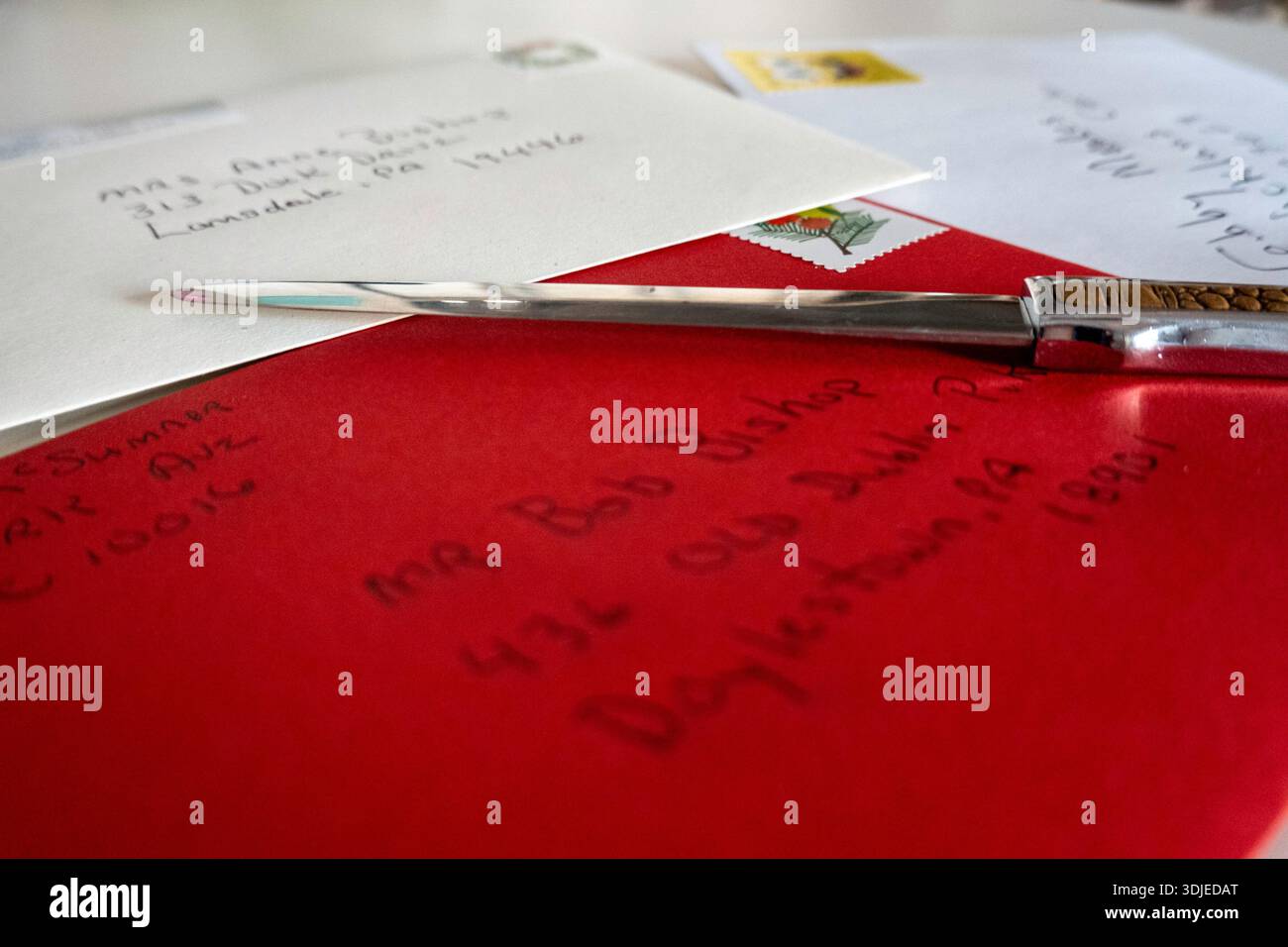 Close up of a metal letter, opener and letter envelopes, 2026, United States Stock Photo