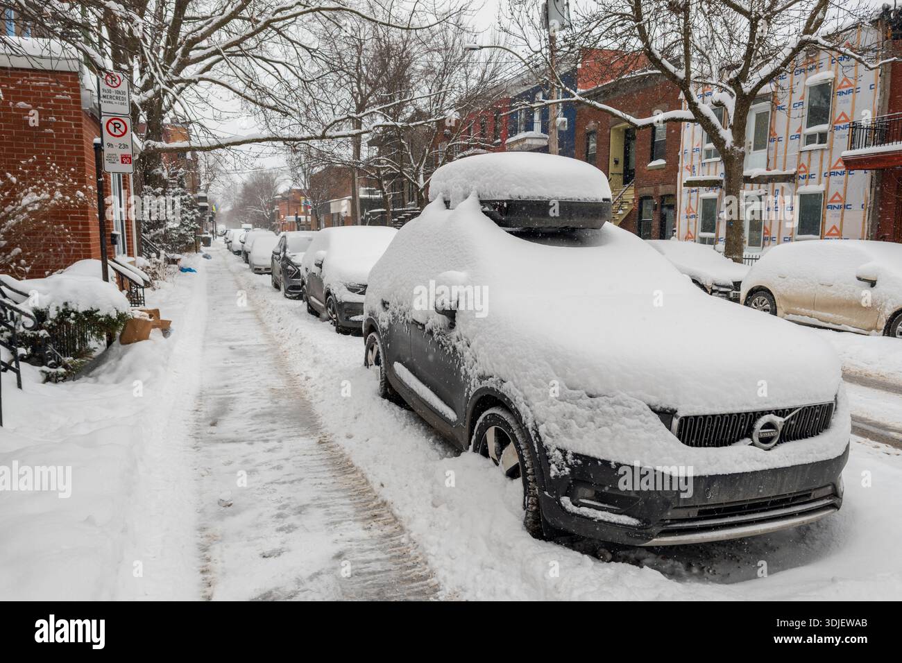 Montreal, CA - 26 January 2026: Cars parked on a snow covered residential street in Plateau Mont Royal - Smartphone Captured Stock Image