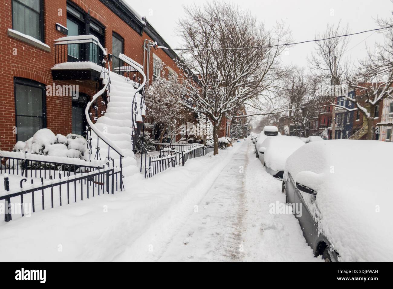 Montreal, CA - 26 January 2026: Set of traditional Montreal outdoor stairs heavily covered in snow during winter storm - Smartphone Captured Stock Image