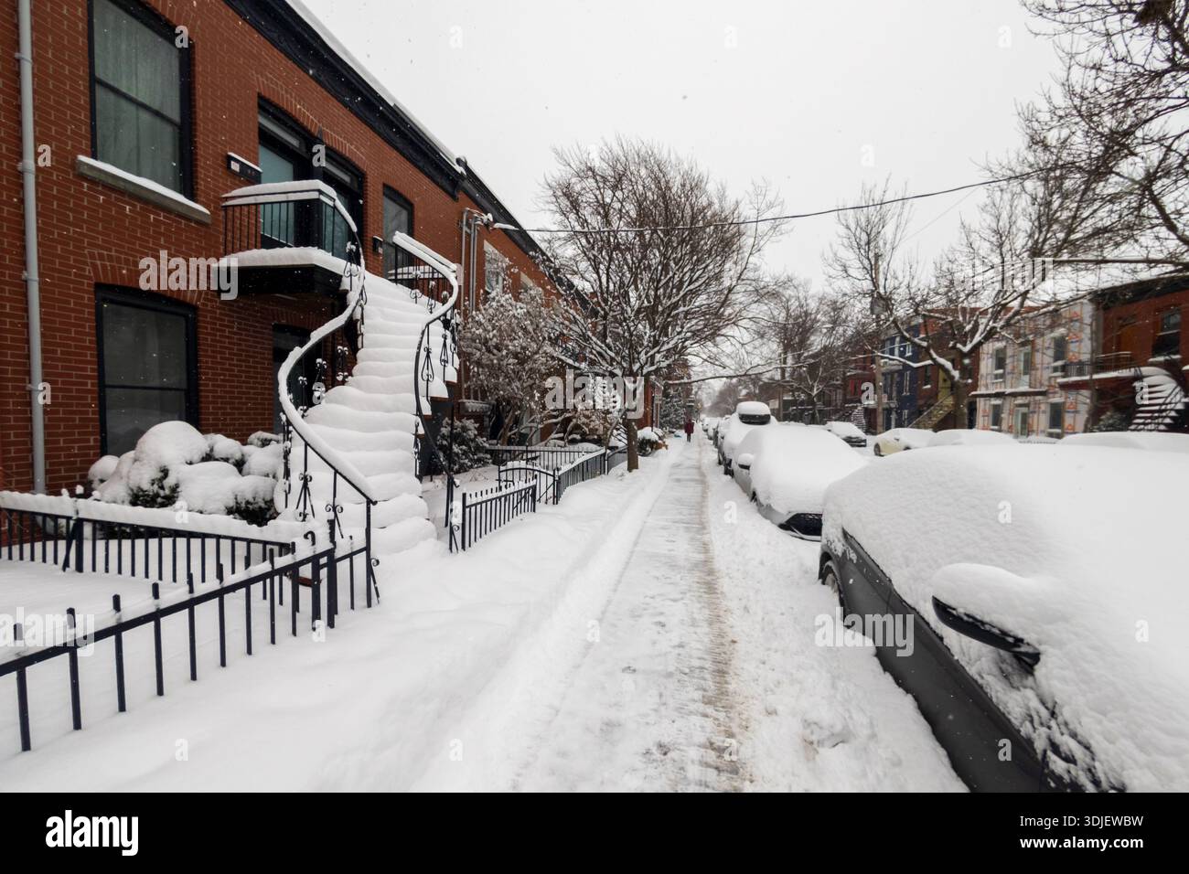 Montreal, CA - 26 January 2026: Set of traditional Montreal outdoor stairs heavily covered in snow during winter storm - Smartphone Captured Stock Image