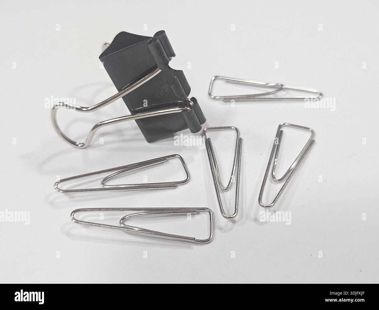 Essential Office Fasteners on White Surface. - Smartphone Captured Stock Image