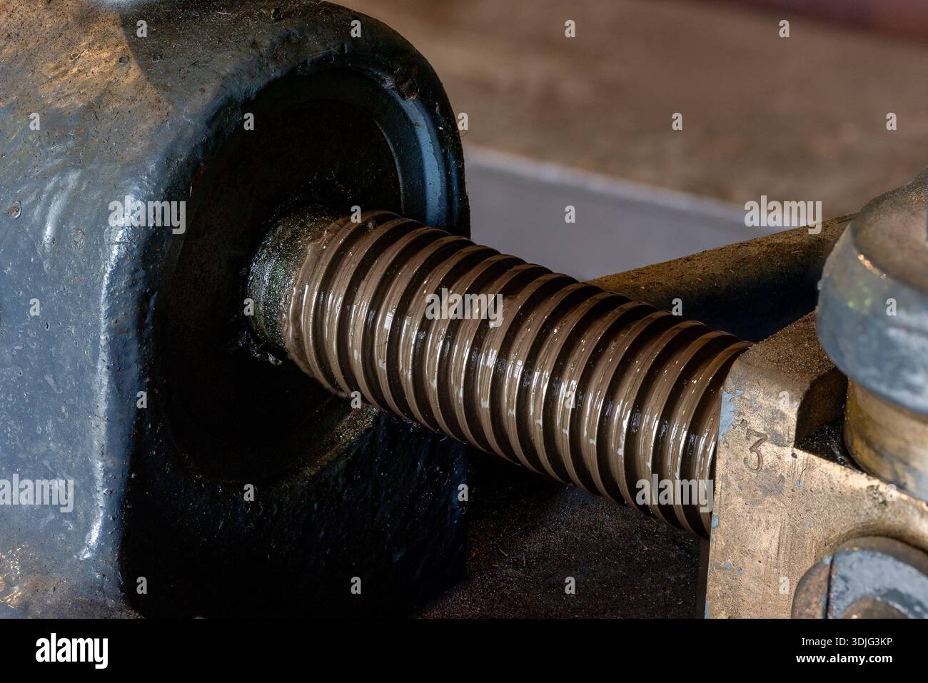 Engine Threading Old industrial machine screw mechanism showing threading and moving ...