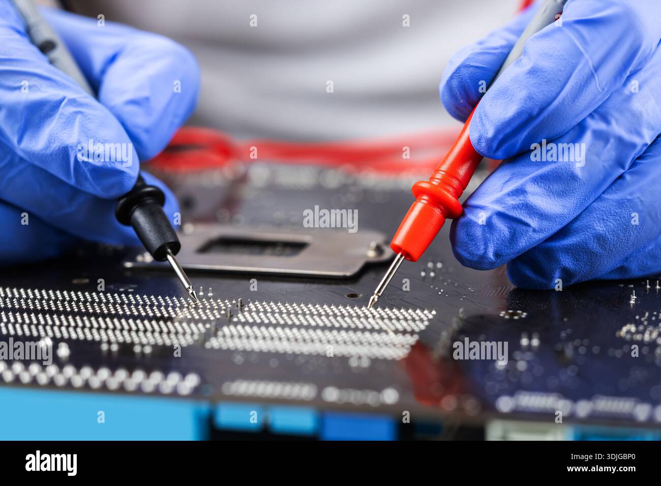 Technician under fixed and repairing computer mainboard process by used multimeter AC Voltage for analysis on computer mainboard is electronic compone Stock Photo