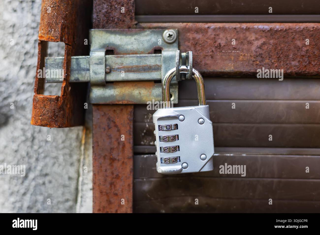 Silver combination padlock on the door. Stock Photo