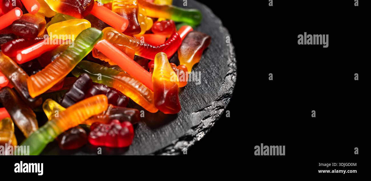 assorted jelly candies floating on black background. Stock Photo