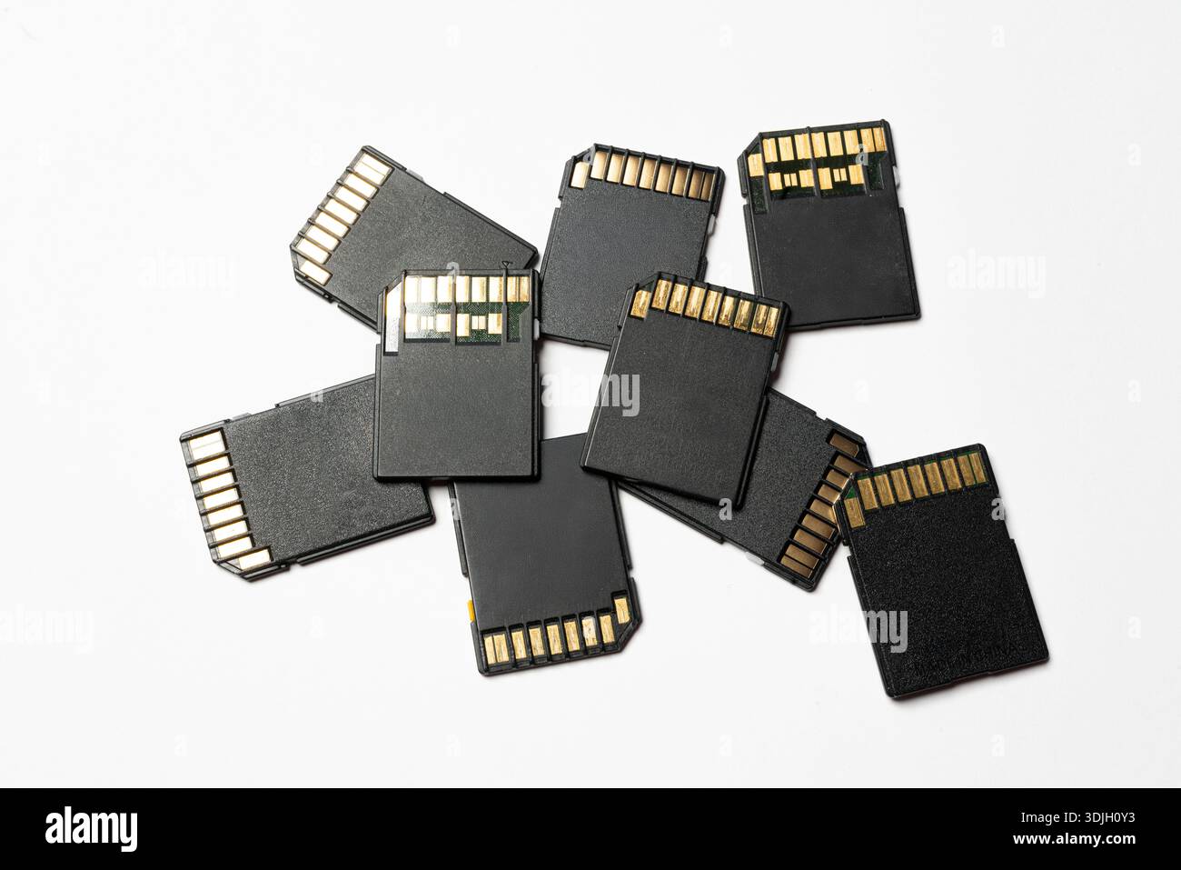 some SD cards on a white surface Stock Photo