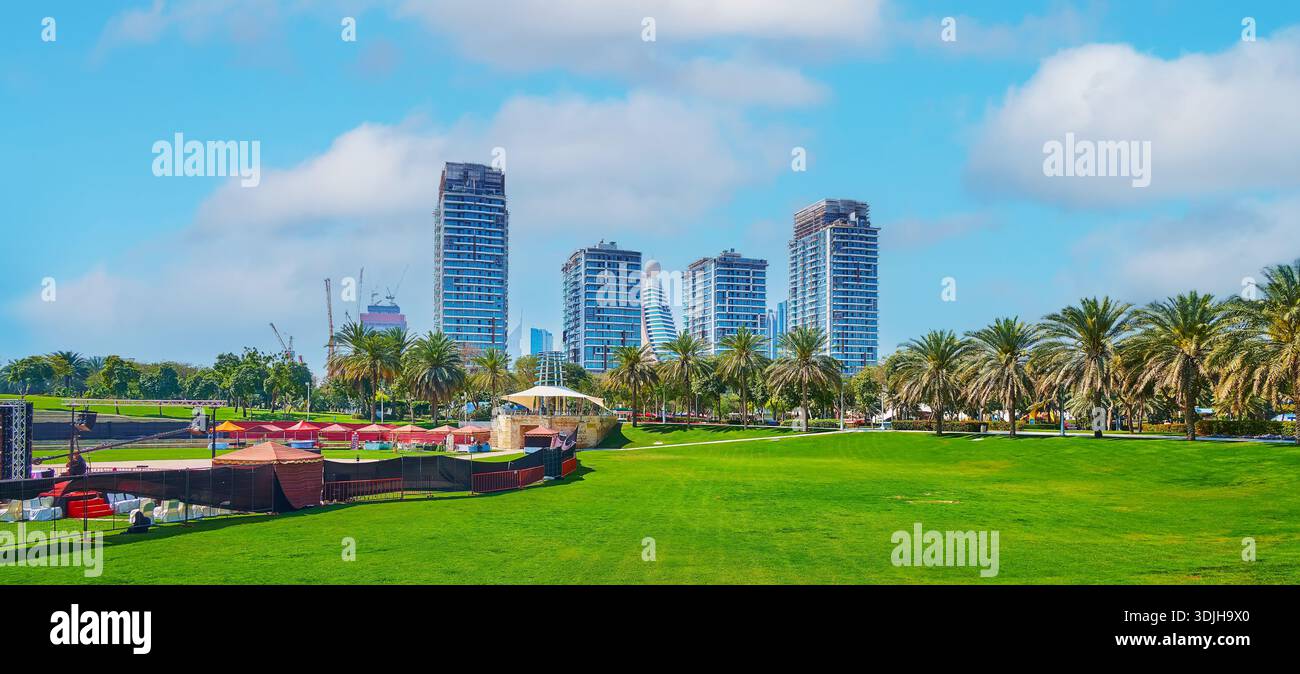 Panorama of Zabeel Park with mown lawn, park theatre, palm alley and ...