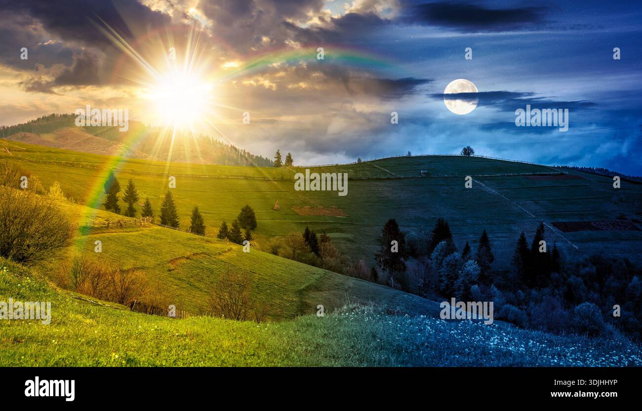 scenery with grassy rural fields near forest on hill. day and night time change concept. countryside landscape on cloudy weather in spring with sun an Stock Photo
