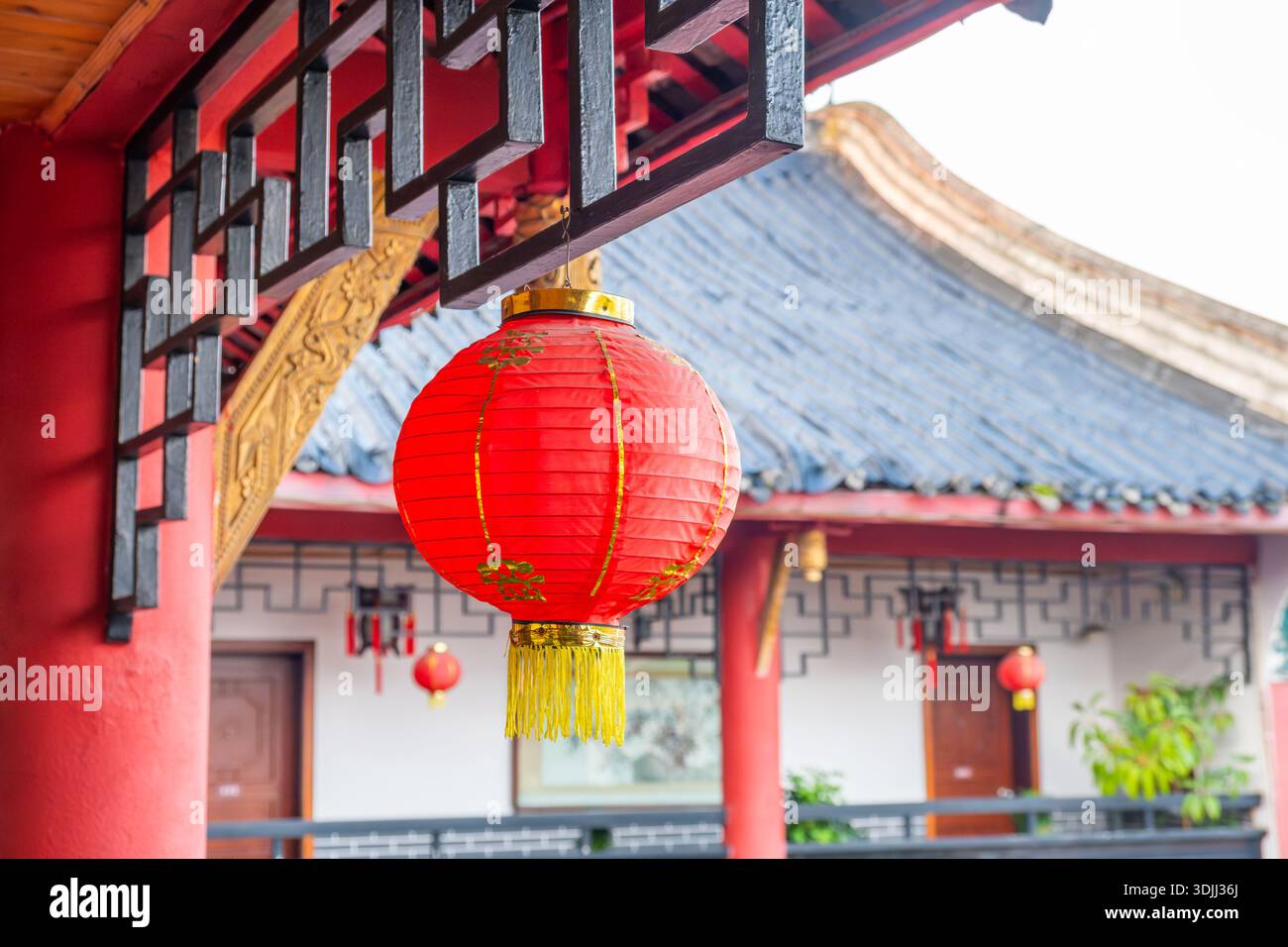 Traditional red Chinese lantern hanging outside a building with Asian ...