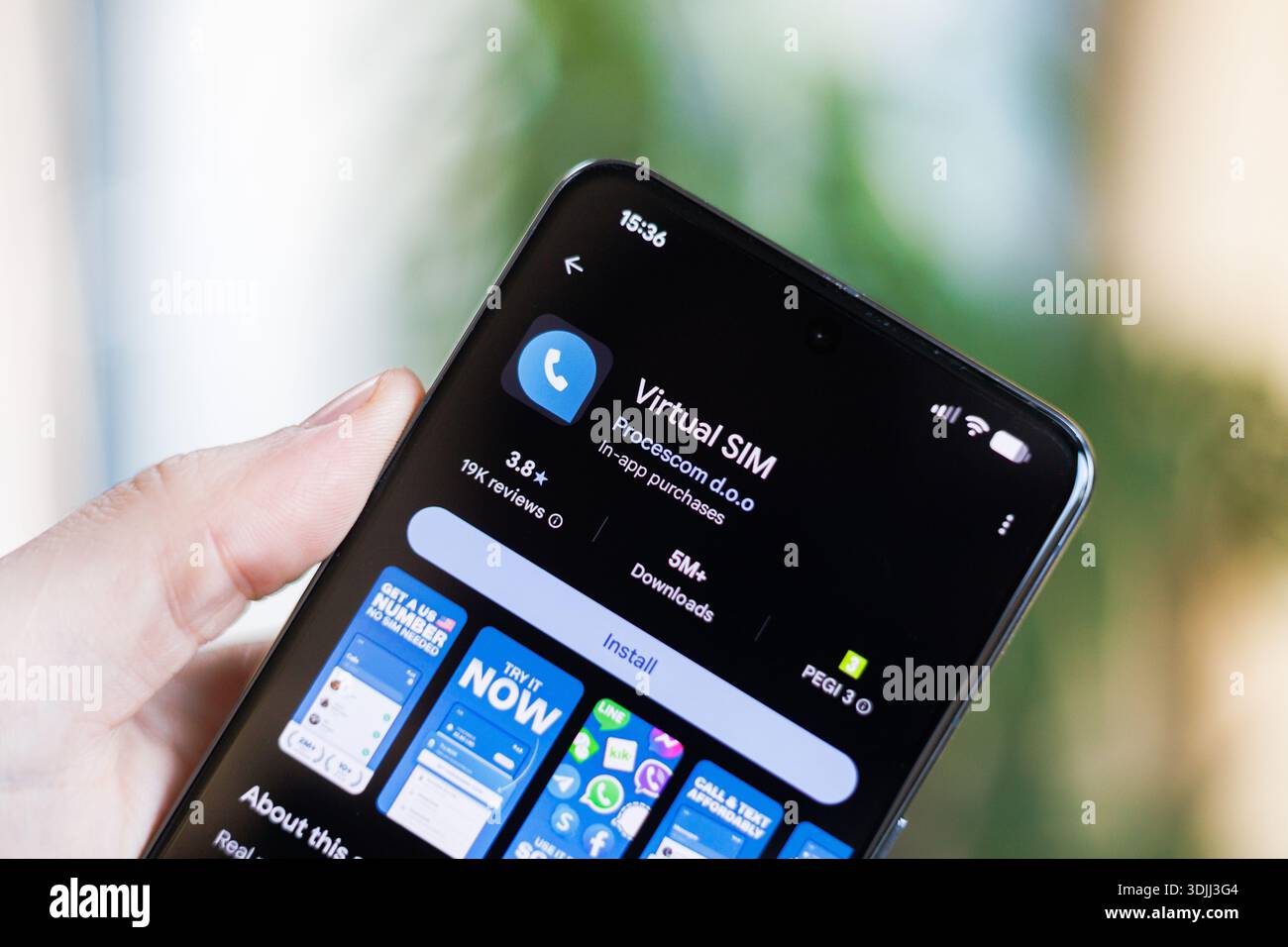 Phone in hand displaying Virtual SIM Card app on Google Play Store Stock Photo