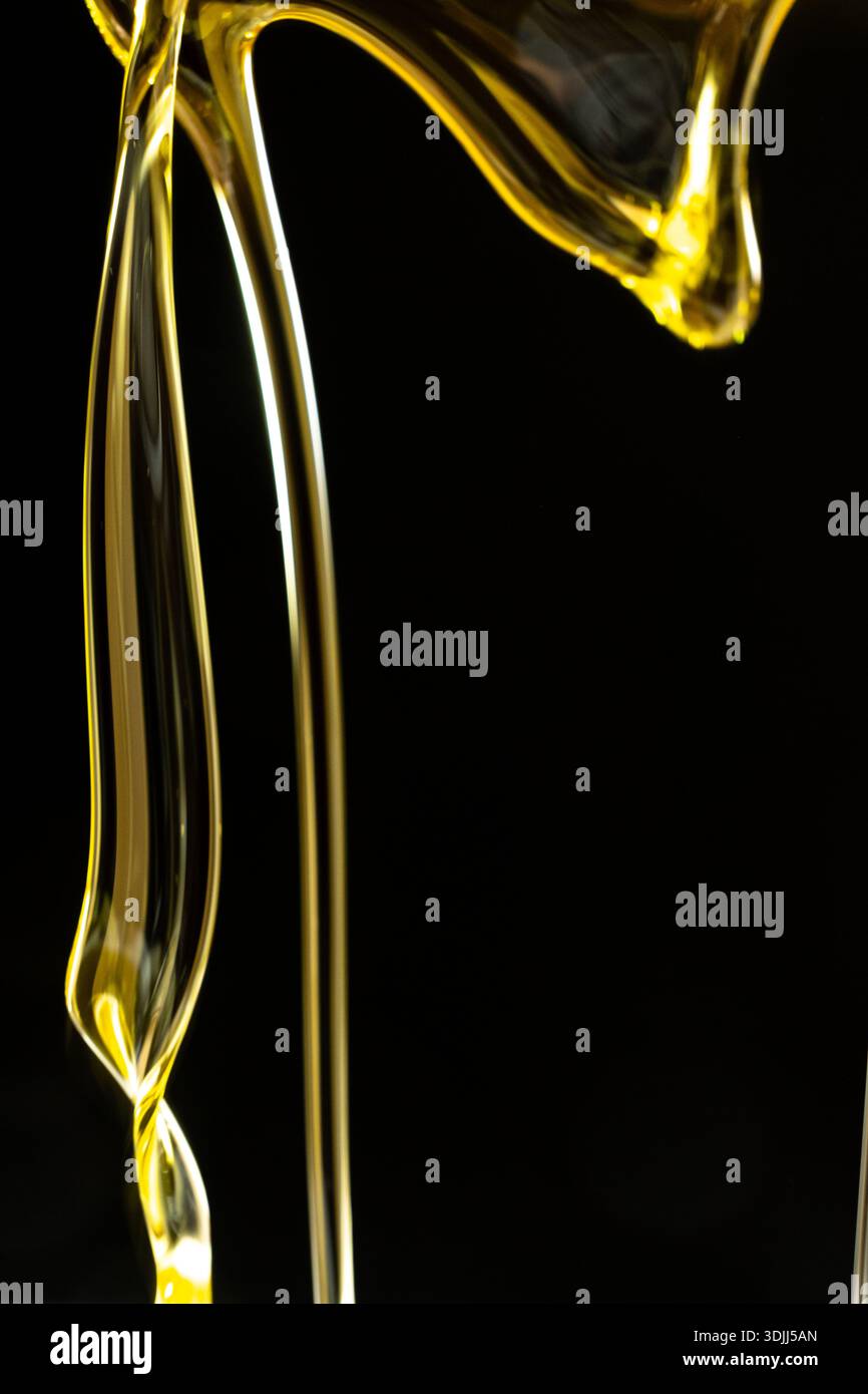 Abstract oil splashes and drips isolated on black for luxury design. Stock Photo